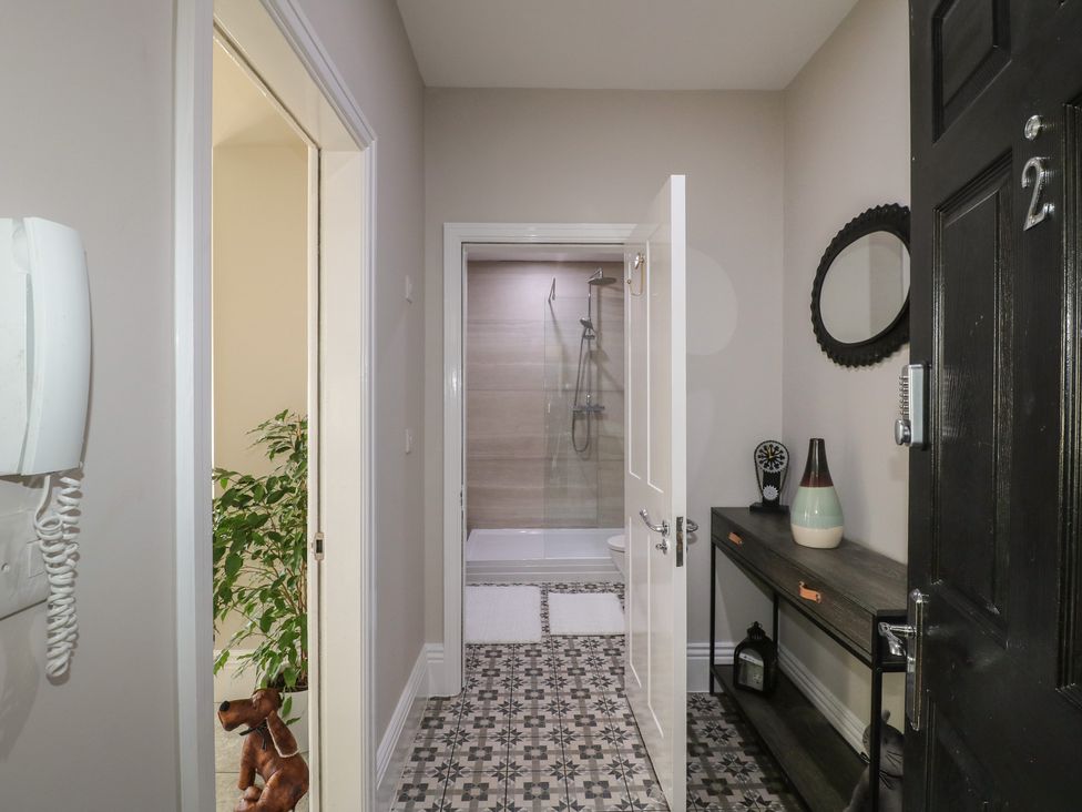 A hallway with a shower door and furniture at Unit 7 Apt 2 Sheffield