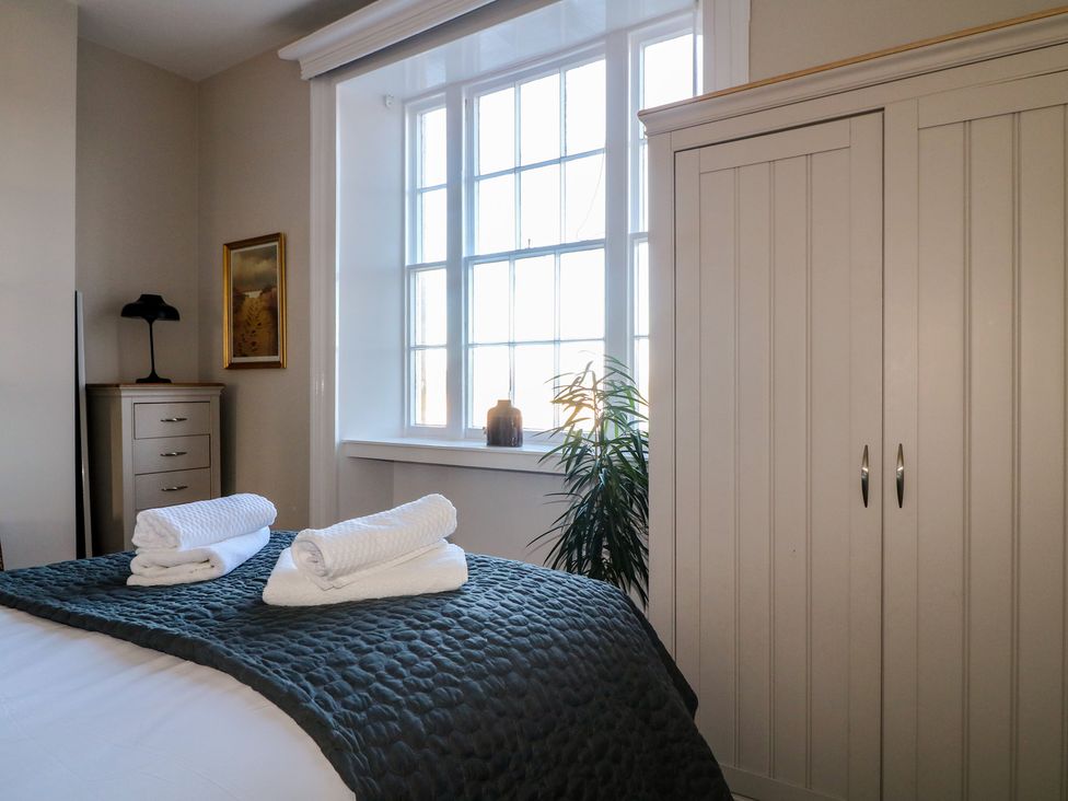 A bedroom with a bed, wardrobe, and window at Unit 7 Apt 3 in Sheffield