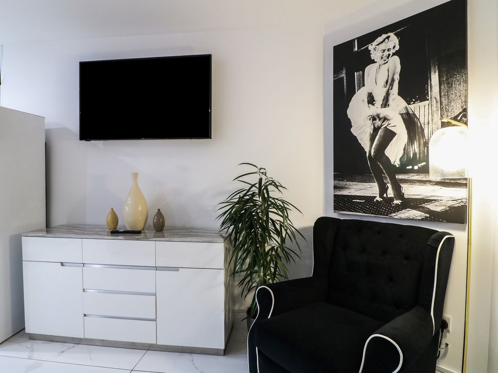 A living room with a television and a chair at Unit 7 Apt 4 in Sheffield