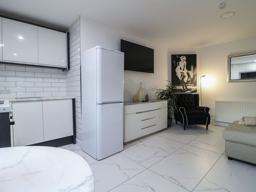 A kitchen with cabinets and refrigerator at Unit 7 Apt 4 Sheffield