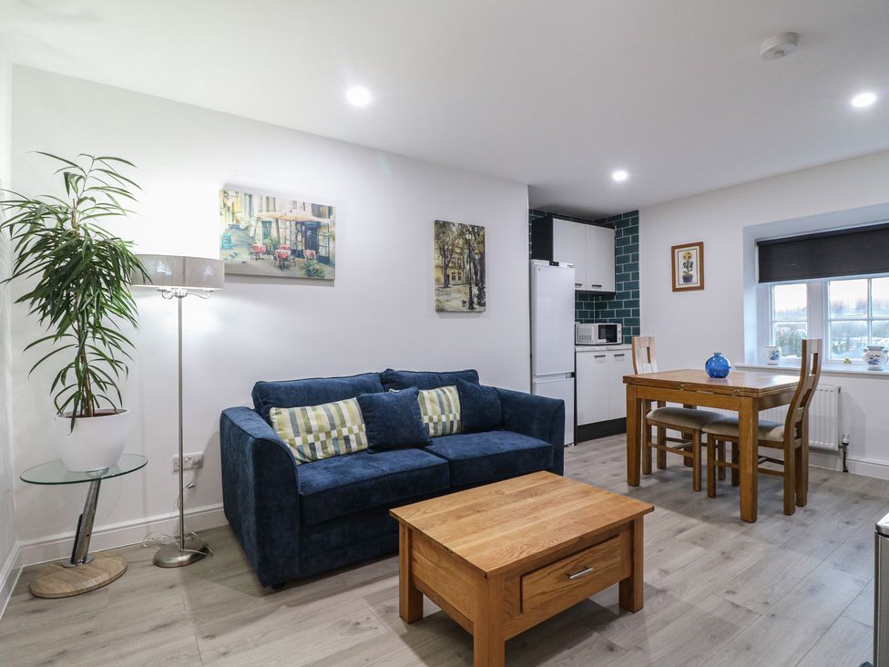 A living room with a sofa and dining area at Unit 7 Apt 5 Sheffield