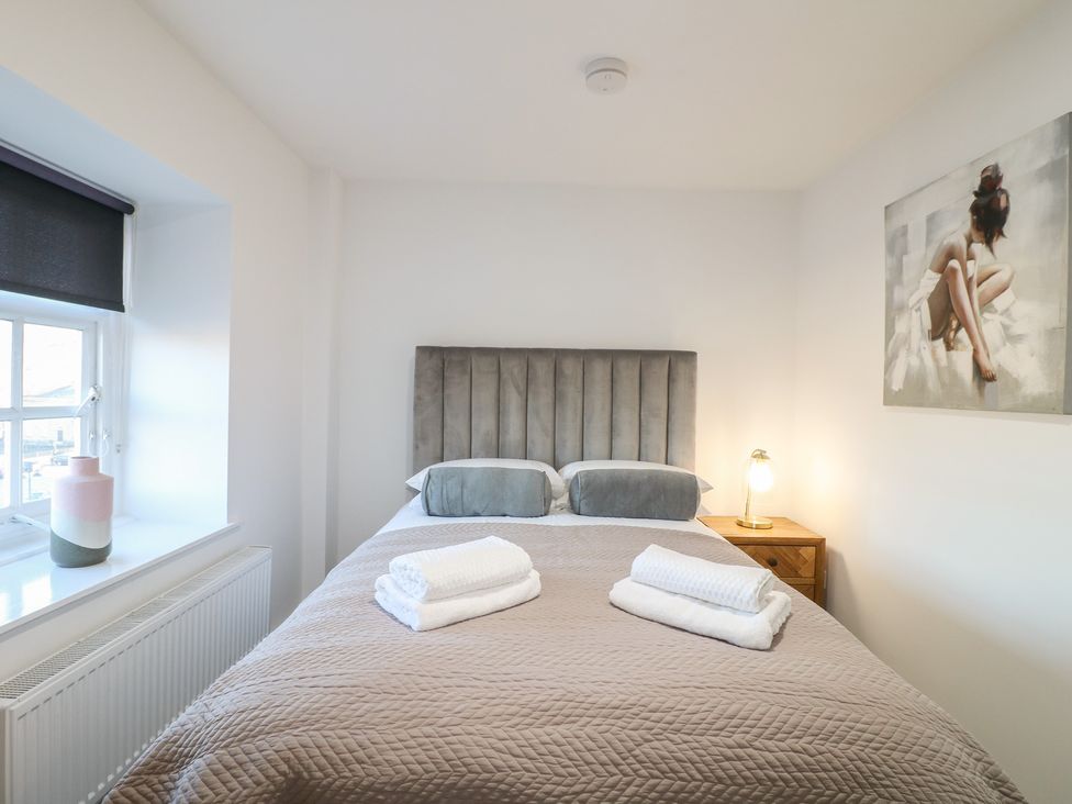 A bedroom with a bed, bedside table, and window at Unit 7 Apt 5 in Sheffield