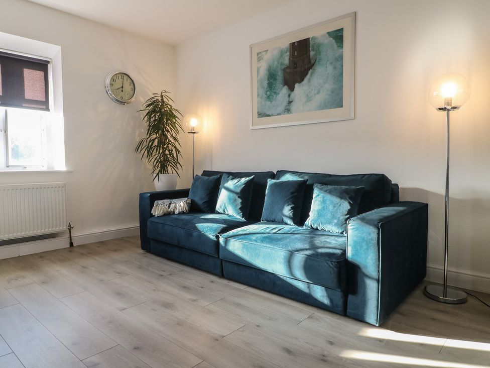 A living room with a sofa and a clock at Unit 7 Apt 6 (Delux) in Sheffield