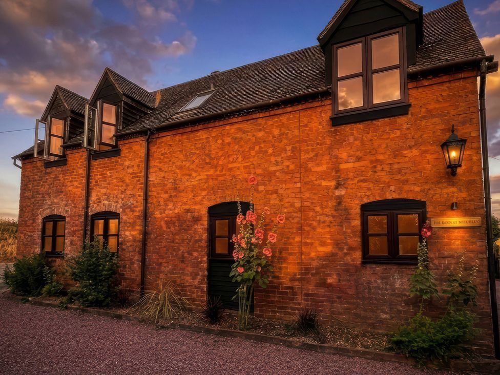 A brick house with windows and door at The Barn at Tytchney near Ombersey and Droitwich Spa