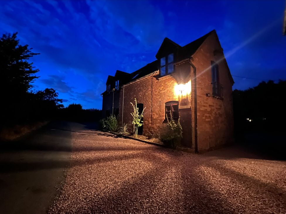 An exterior view of a house with a lamp and gravel driveway at The Barn at Tytchney near Ombersey and Droitwich Spa