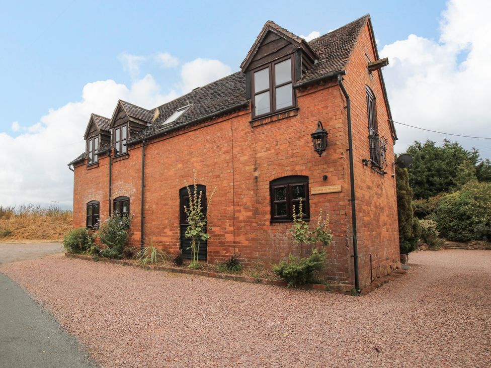 A brick house with windows and a garden at The Barn at Tytchney near Ombersey and Droitwich Spa