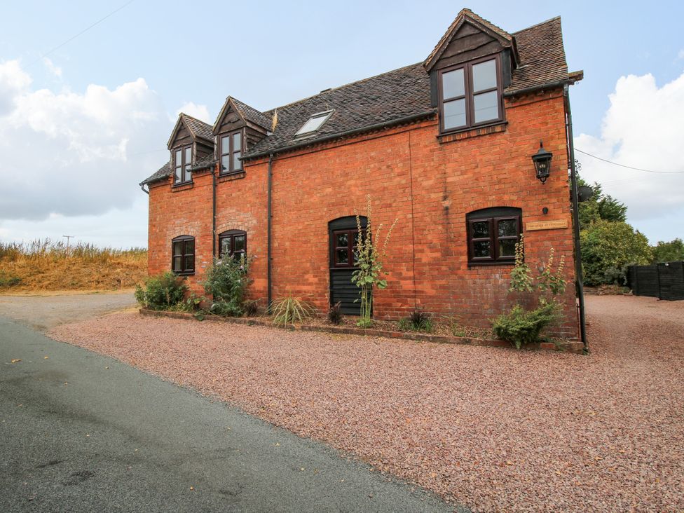 A brick house with windows and a door at The Barn at Tytchney near Ombersey and Droitwich Spa