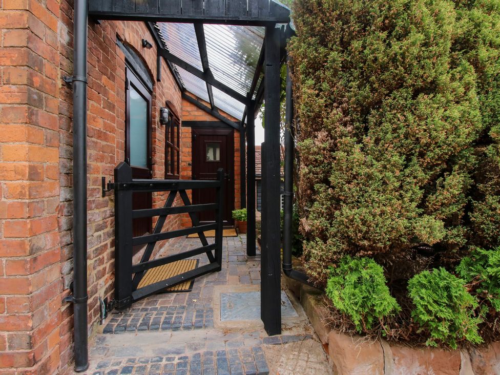 An outdoor entrance with a gate and plants at The Barn at Tytchney near Ombersey and Droitwich Spa
