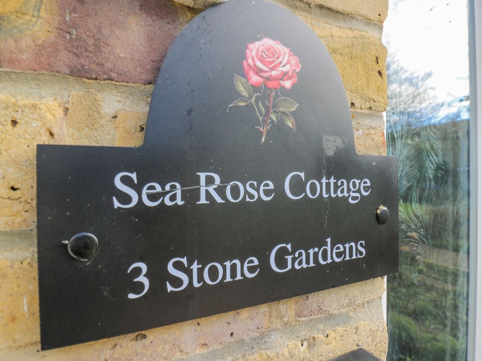 A plaque displaying Sea Rose Cottage at 3 Stone Gardens
