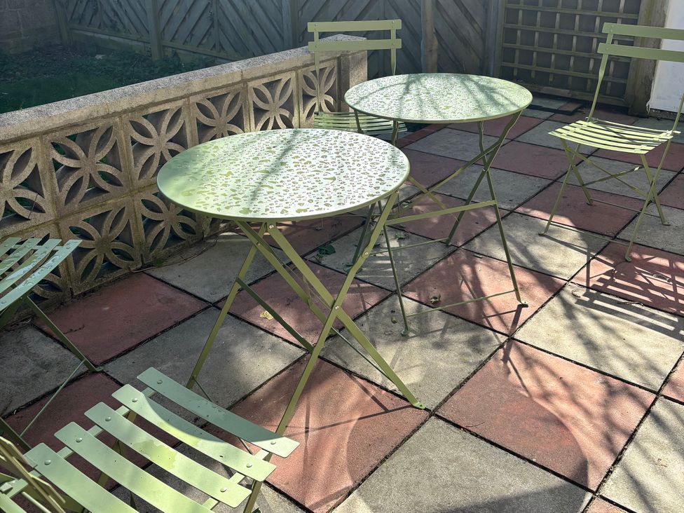 A table and chairs on a patio at Sea Rose Cottage in Broadstairs