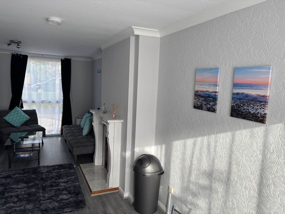 A living room with a sofa and coffee table at Sea Rose Broadstairs Broadstairs