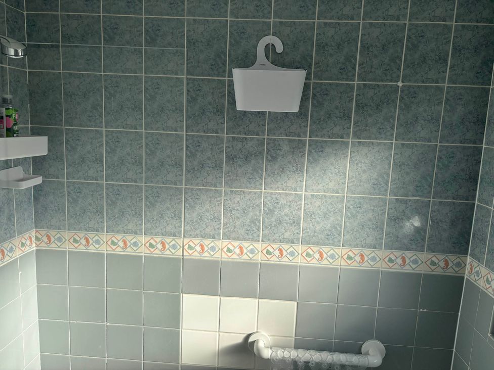 A bathroom with tiled walls and shower fixtures at Sea Rose Broadstairs, Broadstairs