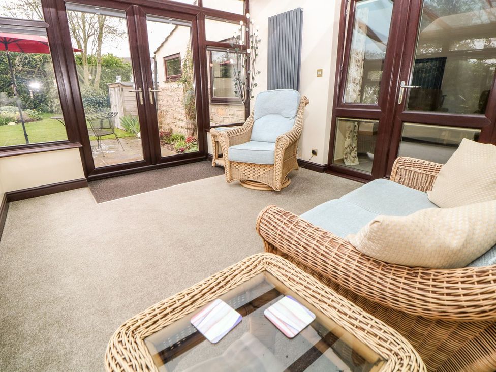 A conservatory with wicker furniture at Millers Retreat in Chesterfield