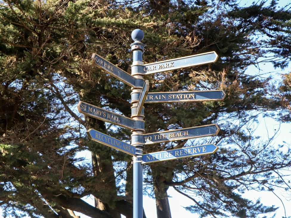 A signpost with directions to various locations at Upper Longlands in Dawlish