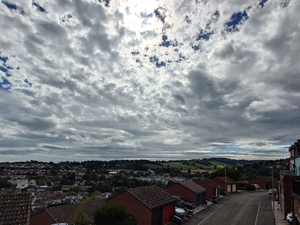 A view of clouds and hills from a parking area at Upper Longlands Dawlish