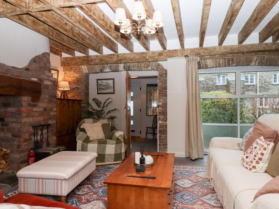 A living room with furniture and a fireplace at Garden Cottage at the Bowden Estate Stoke Fleming