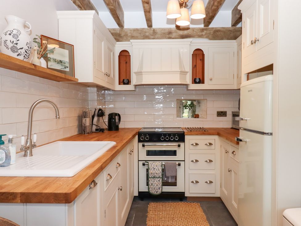 A kitchen with a cooking range and sink at Garden Cottage at the Bowden Estate Stoke Fleming