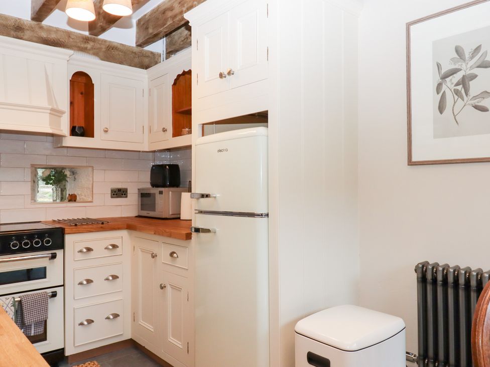 A kitchen with appliances and cabinets at Garden Cottage at the Bowden Estate Stoke Fleming