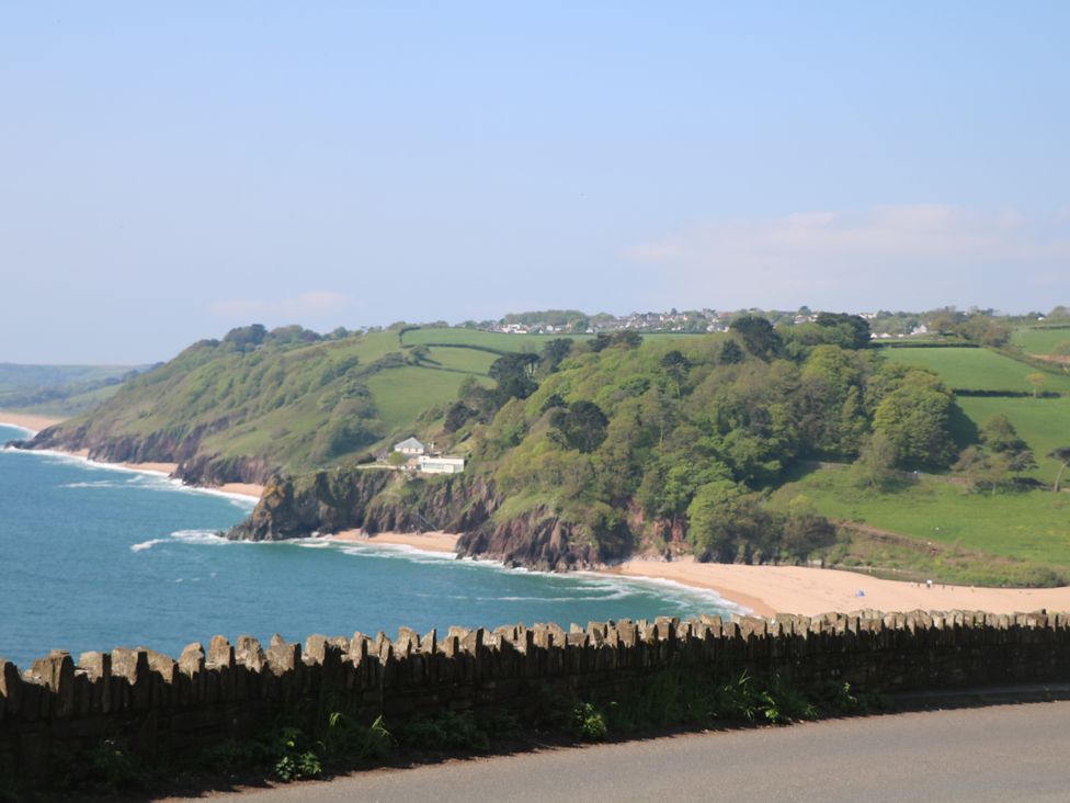 A beach and cliffs with trees and houses at Garden Cottage at the Bowden Estate Stoke Fleming