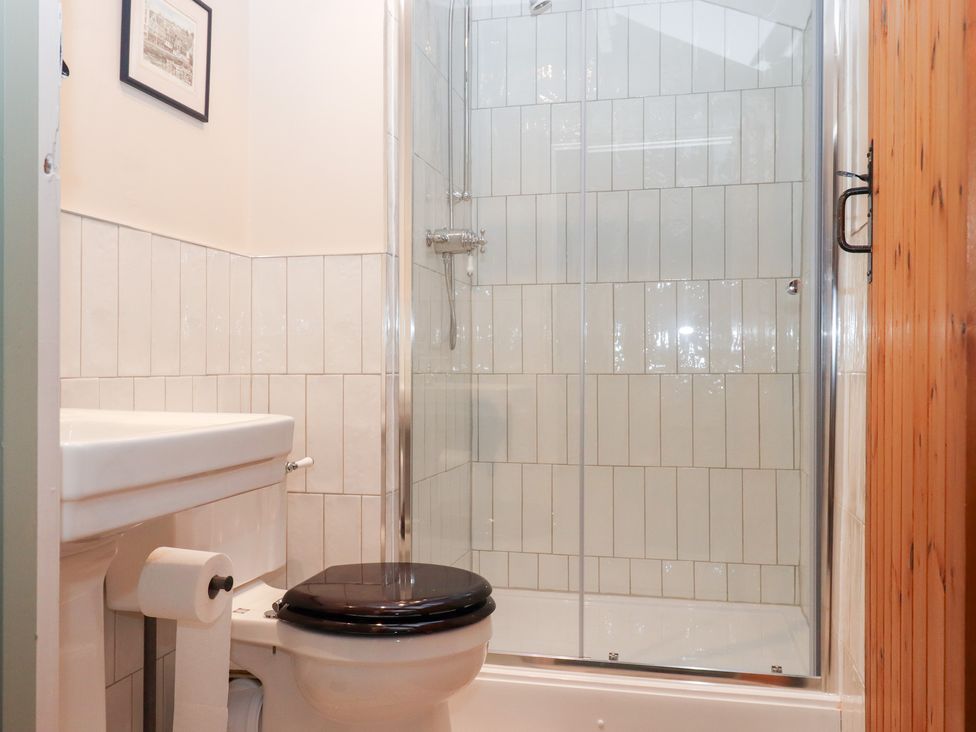 A bathroom with a shower and toilet at Garden Cottage at the Bowden Estate Stoke Fleming