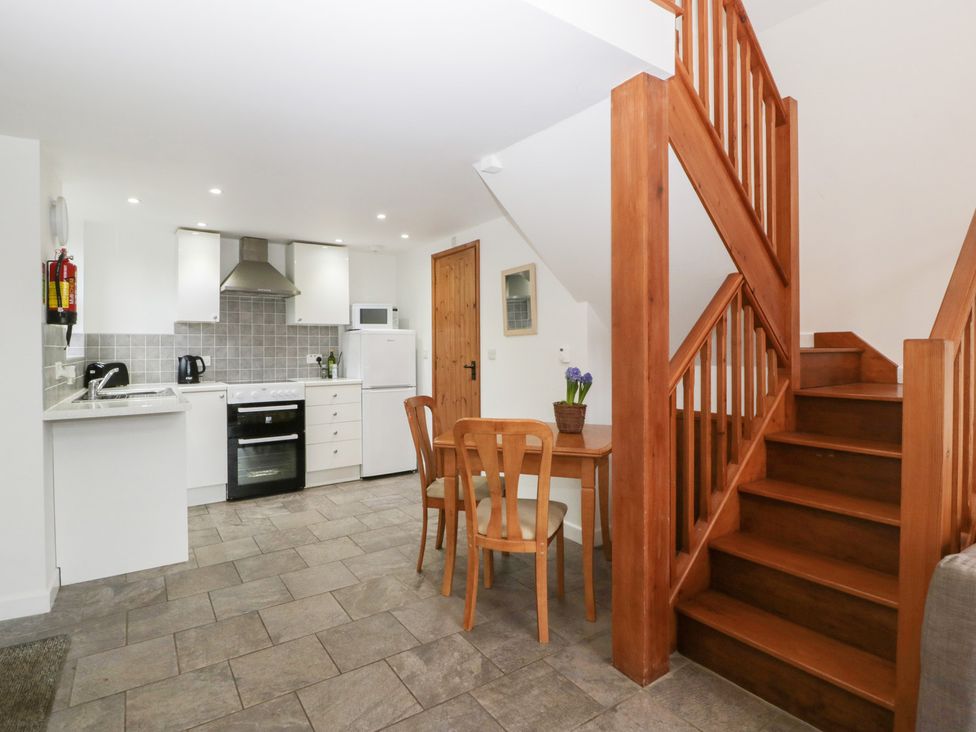 A kitchen area with a table and chairs at Horse Gin in Lydney