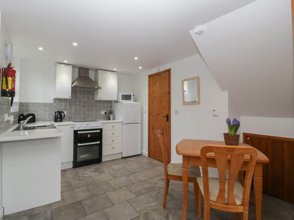 A kitchen with appliances and a dining area at Horse Gin in Lydney