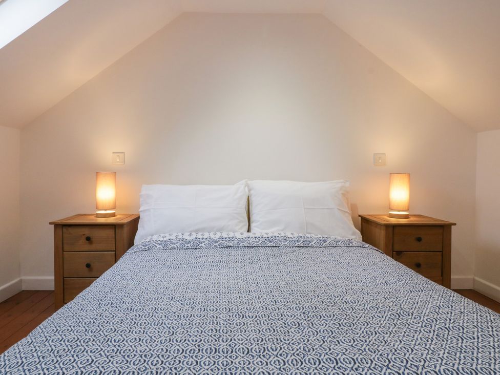 A bedroom with a bed and nightstands at Horse Gin in Lydney