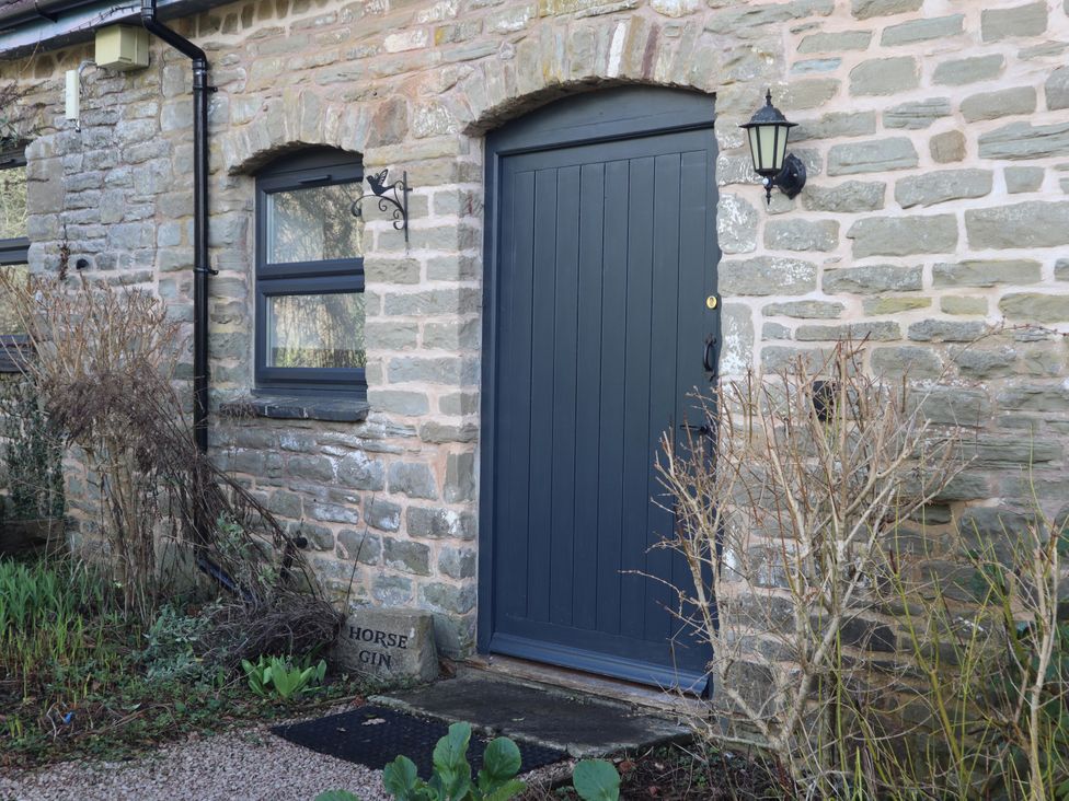 A door and window with a stone wall at Horse Gin in Parkend