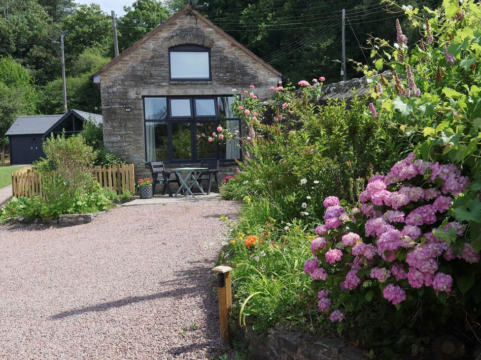 A house with flowers and a pathway at Horse Gin in Parkend