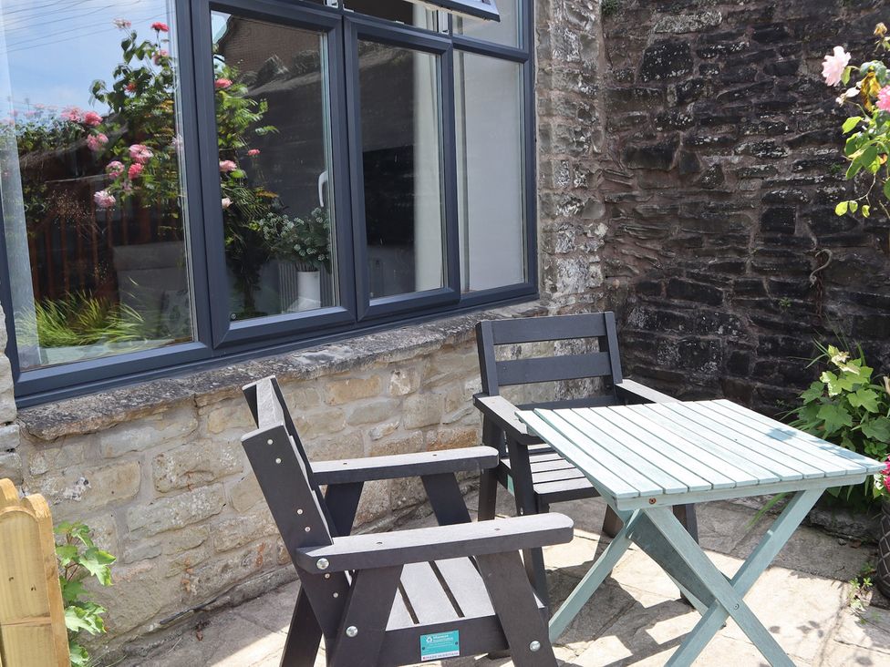 An outdoor seating area with a table and chairs at Horse Gin in Parkend