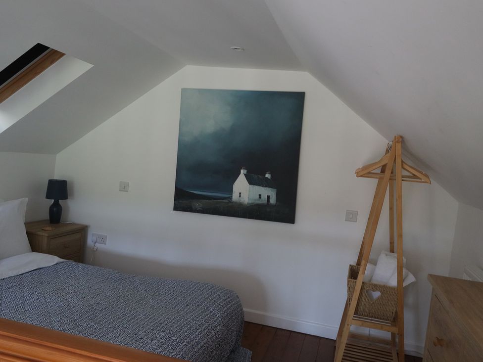 A bedroom with a bed, lamp, and painting at Horse Gin, Parkend