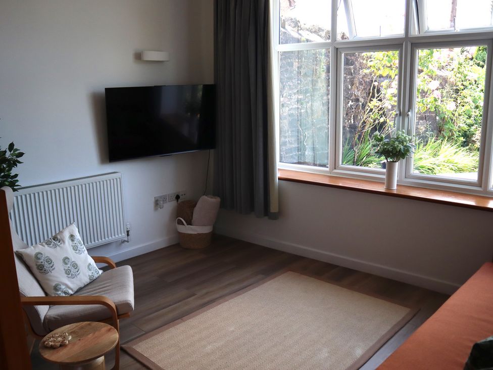 A living room with a television and a chair at Horse Gin in Parkend