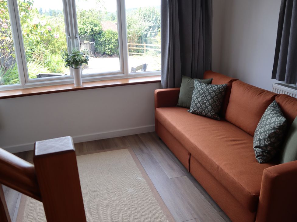 A living room with a sofa and a view outside at Horse Gin in Parkend
