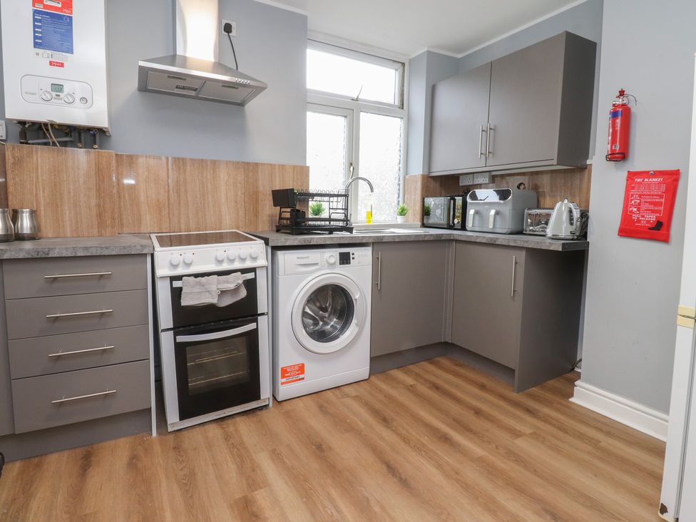 A kitchen with appliances and counter space at 38B Yorkshire Street Morecambe