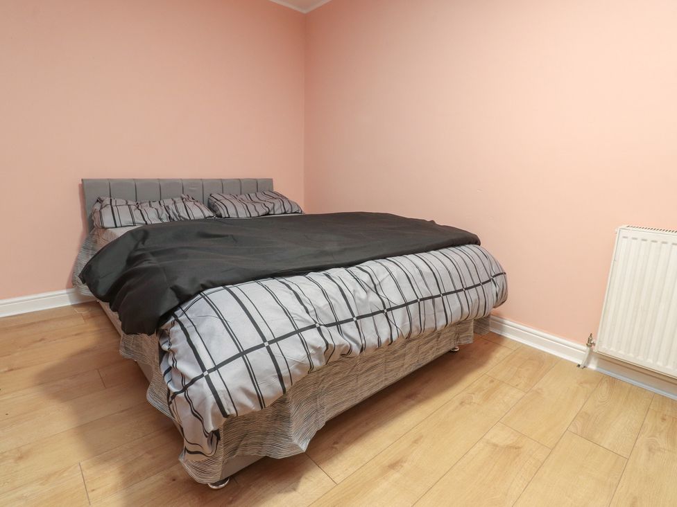 A bedroom with a bed and radiator at 38B Yorkshire Street, Morecambe