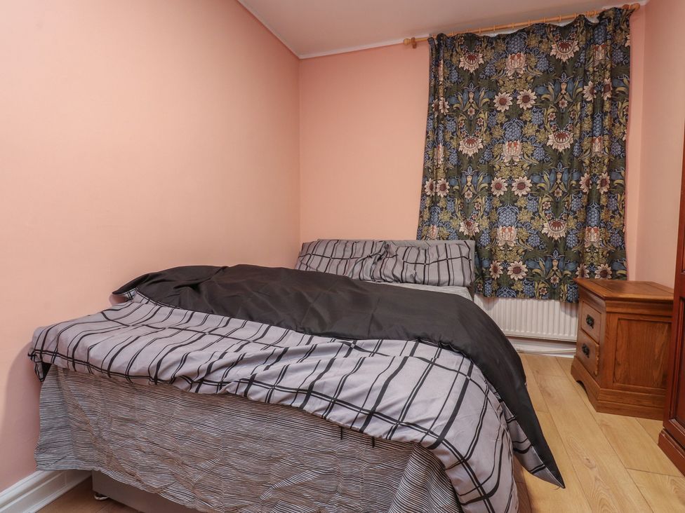 A bedroom with a bed and bedside table at 38B Yorkshire Street Morecambe