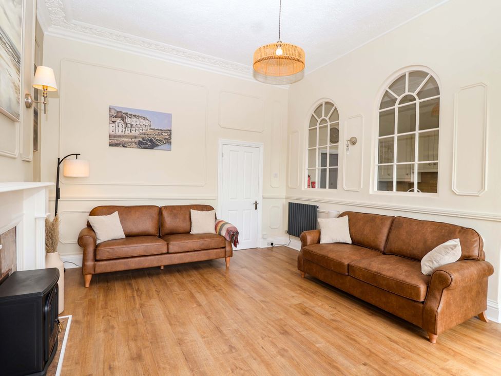 A living room with two sofas and a fireplace at Flat 2 The Moorings in Torquay