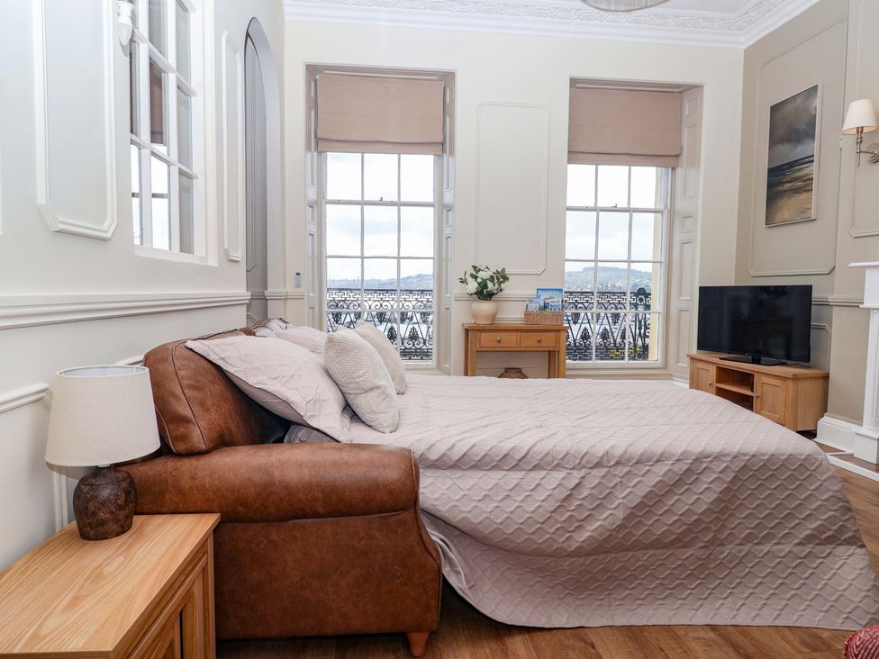 A bedroom with a bed and television at Flat 2 The Moorings in Torquay