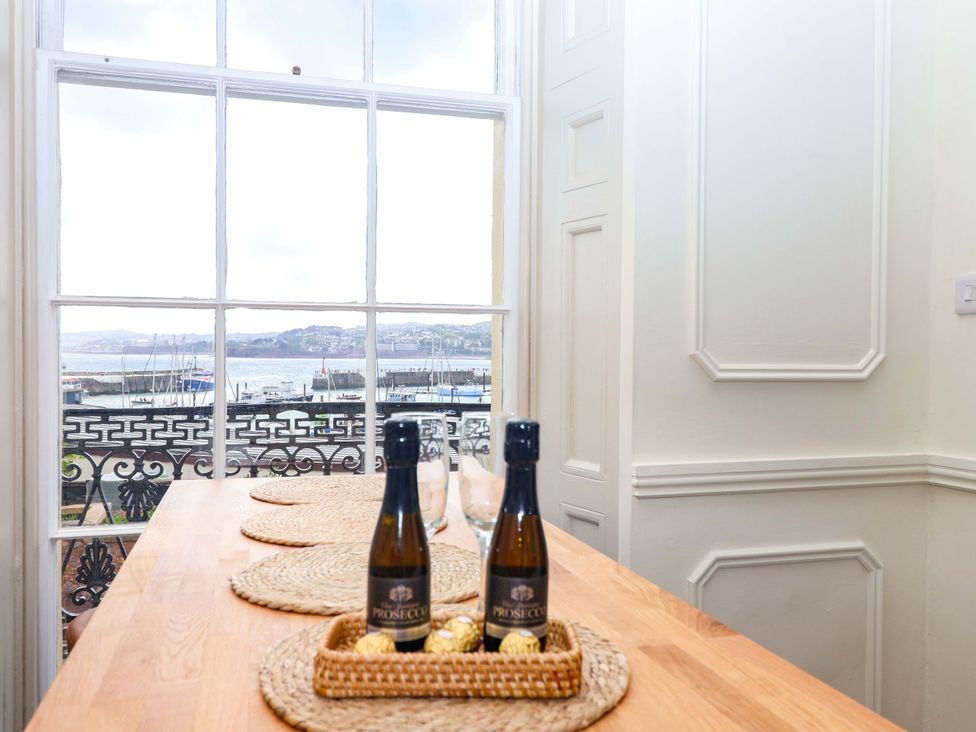 A kitchen with a view of the harbor at Flat 2 The Moorings Torquay