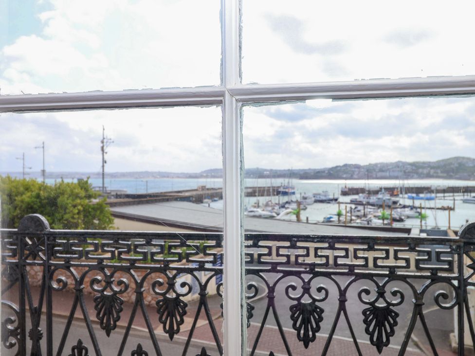 A view of the sea and boats from a window at Flat 2 The Moorings in Torquay