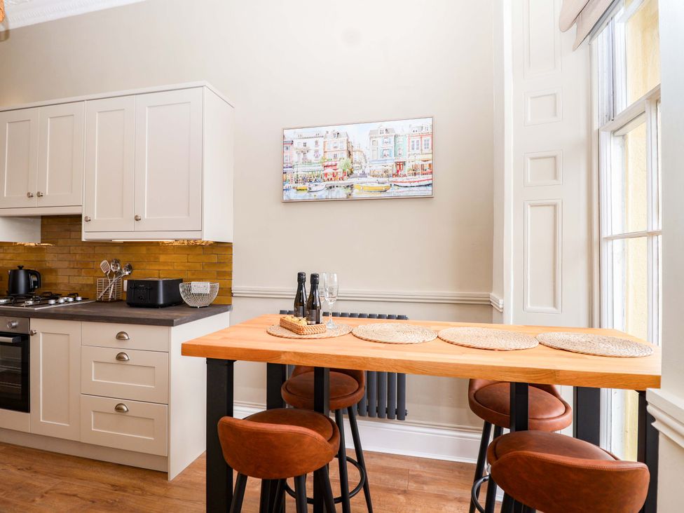 A kitchen with cabinets and a counter at Flat 2 The Moorings in Torquay