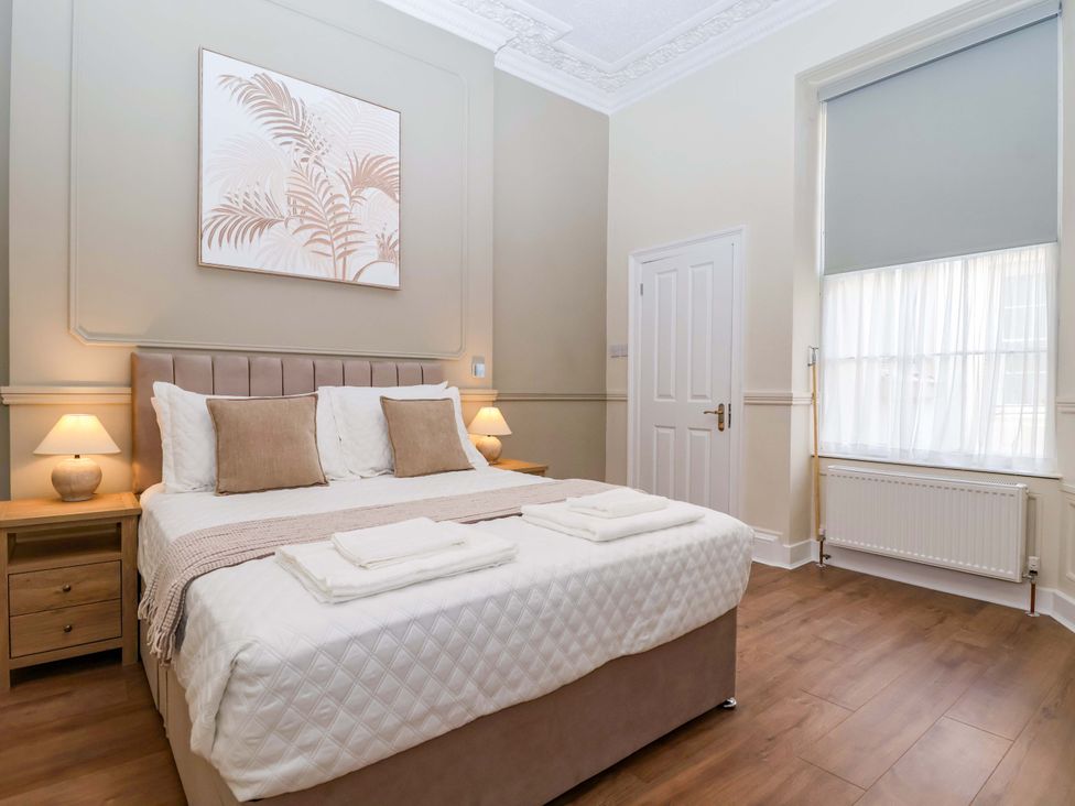A bedroom with a bed and bedside lamps at Flat 2 The Moorings in Torquay