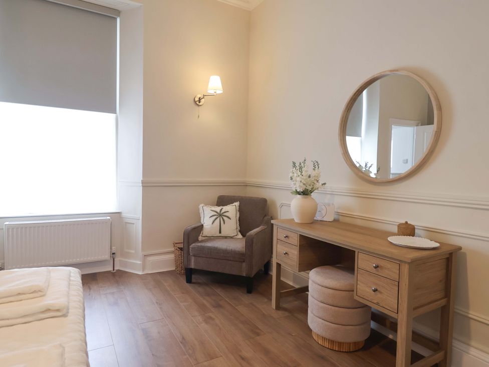 A bedroom with a desk and chair at Flat 2 The Moorings Torquay