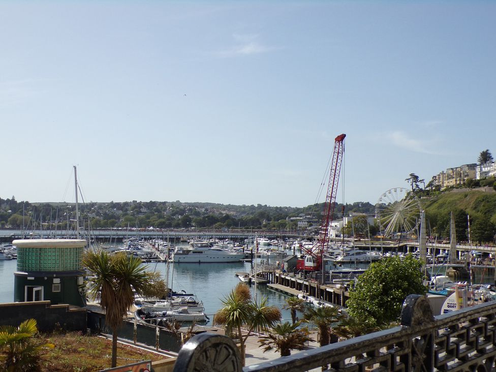 A marina with boats and a ferris wheel at Flat 2 The Moorings Torquay
