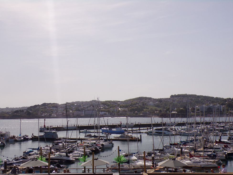 A marina with various boats and hills in the background at Flat 2 The Moorings in Torquay