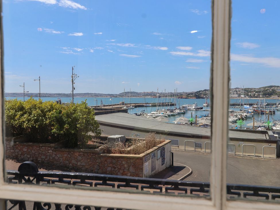 A view of boats in a harbor from a window at Flat 2 The Moorings Torquay