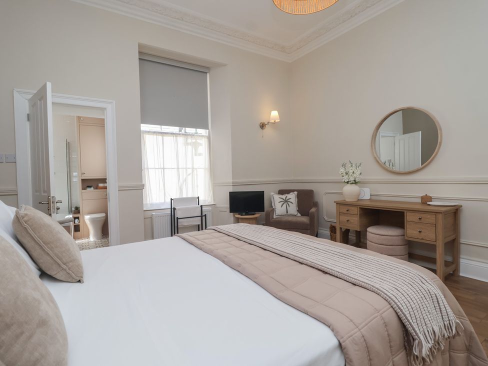 A bedroom with a bed and a desk at Flat 2 The Moorings in Torquay