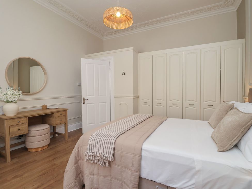 A bedroom with a bed and wardrobe at Flat 2 The Moorings Torquay