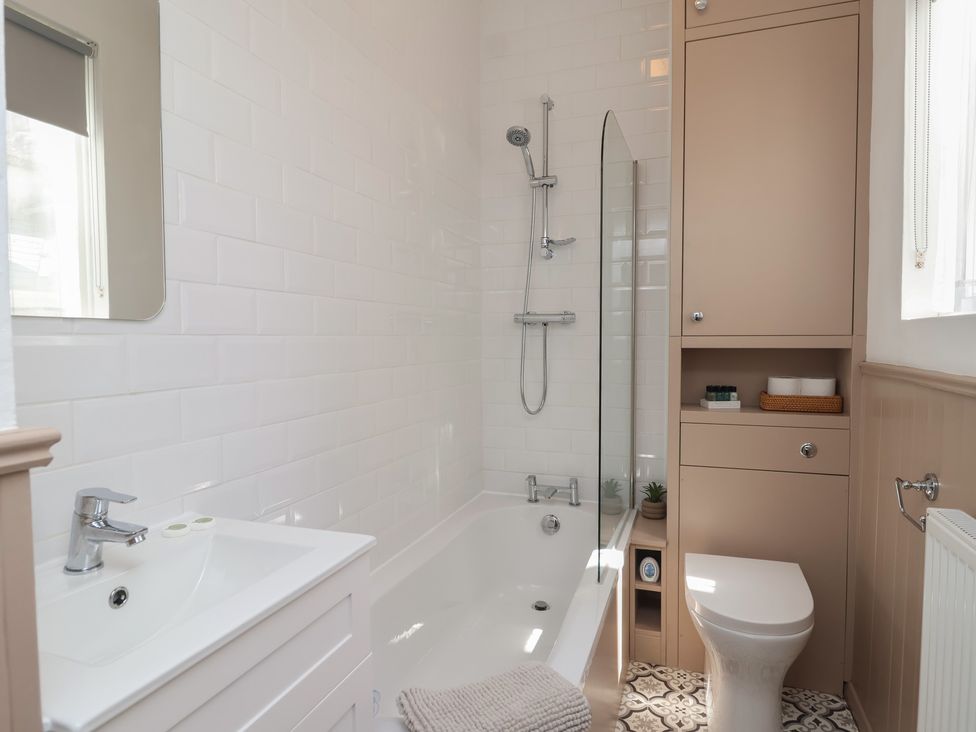 A bathroom with a bathtub and shower at Flat 2 The Moorings in Torquay