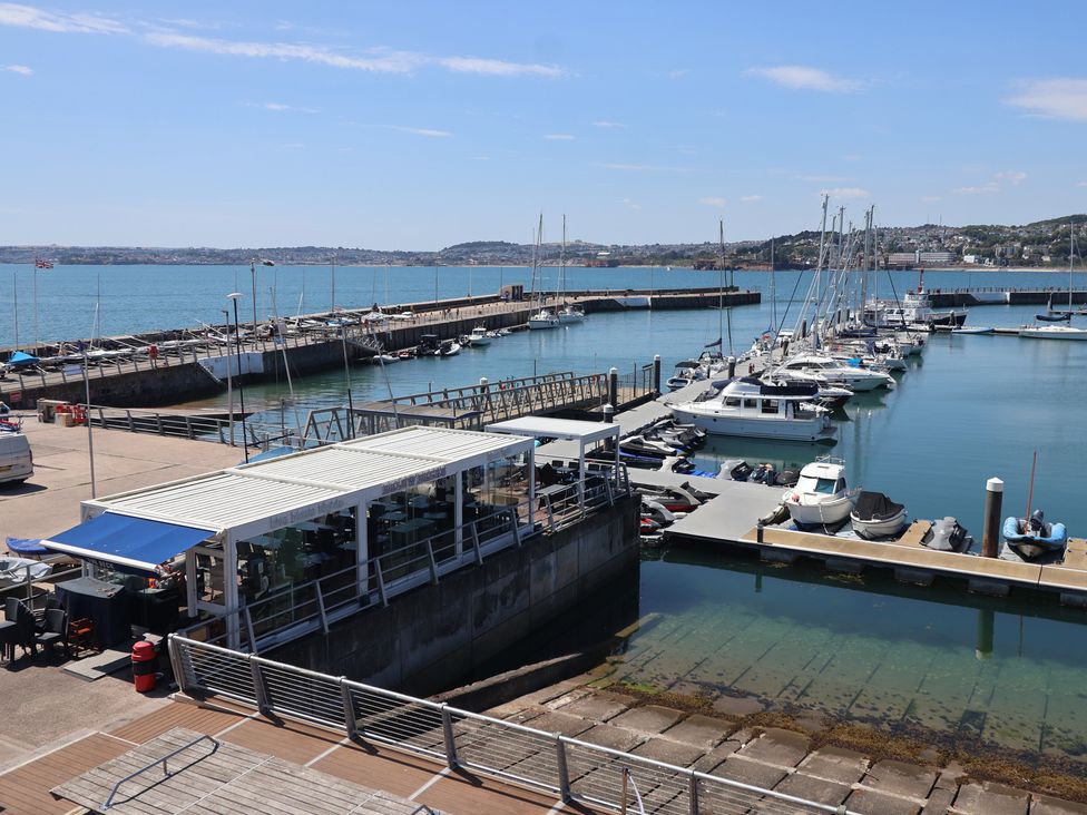 View of a marina with boats and a building at Flat 2 The Moorings Torquay